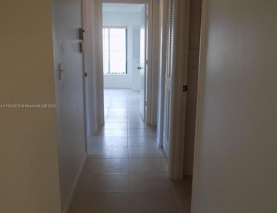 824 Sky Pine Way, Unit A1 West Palm Beach, FL 33415 - Photo 6 of 9 a view of a hallway with wooden floor