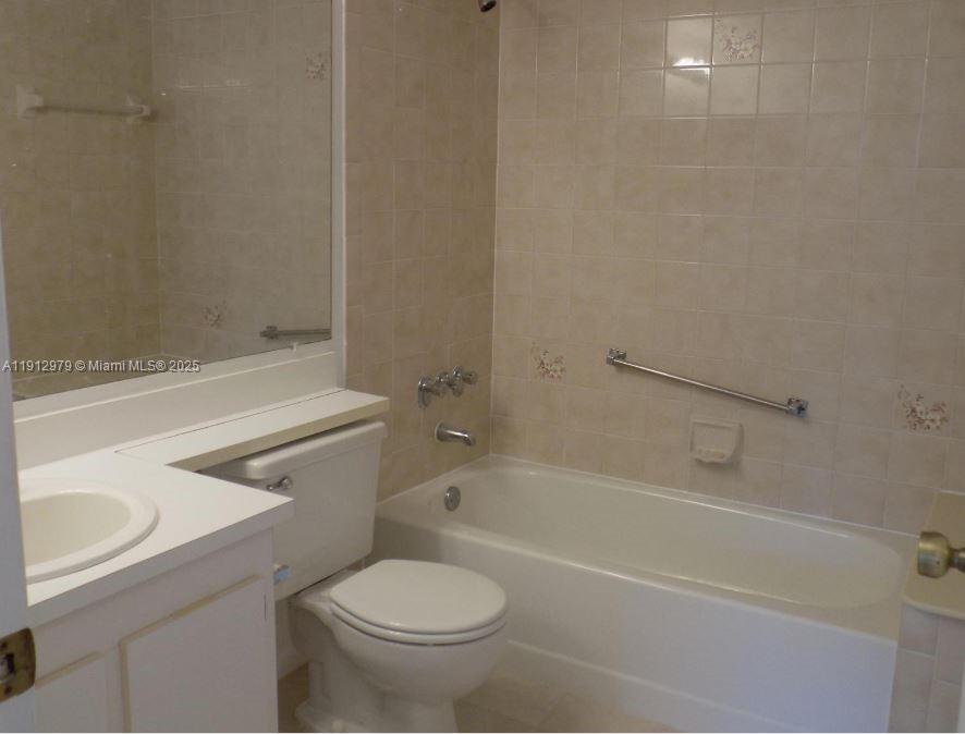 824 Sky Pine Way, Unit A1 West Palm Beach, FL 33415 - Photo 8 of 9 a bathroom with a sink and a toilet