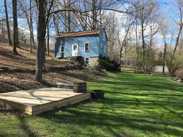a view of a house with backyard and sitting area