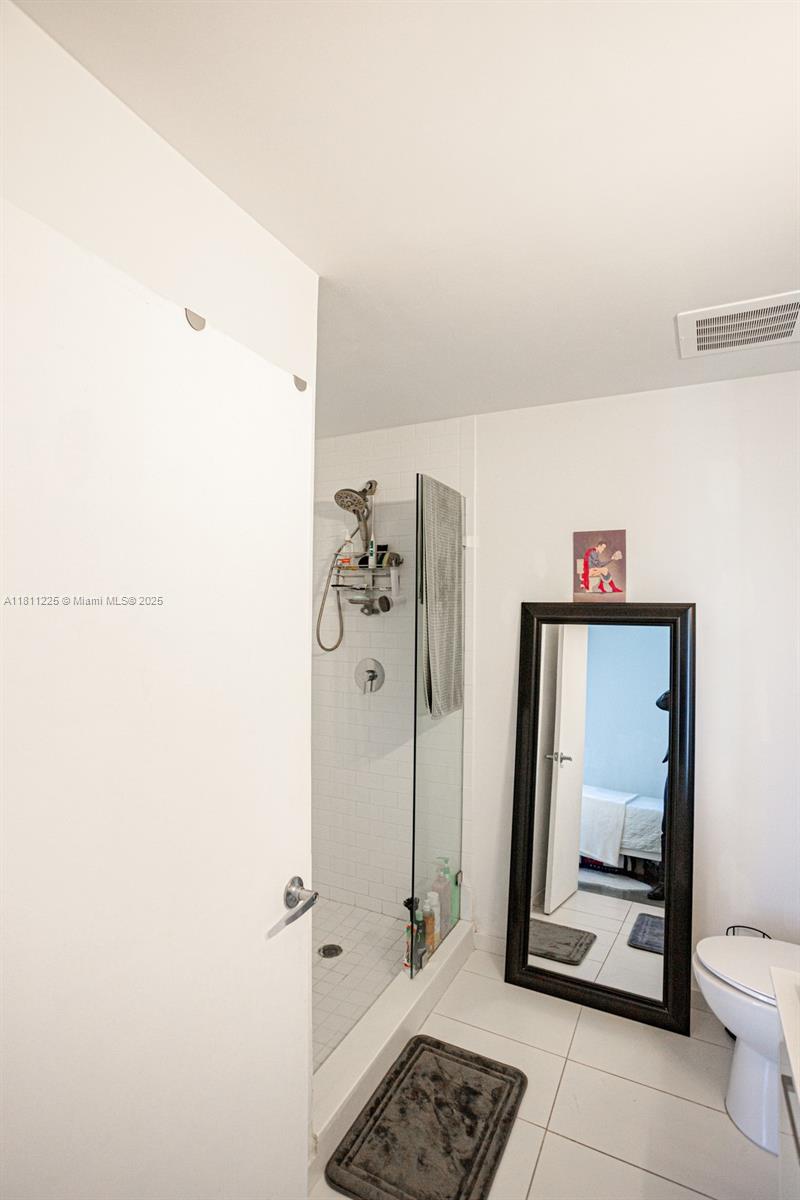 151 Southeast 1st Street, Unit 2204 Miami, FL 33131 - Photo 12 of 34 a bathroom with a toilet and a shower