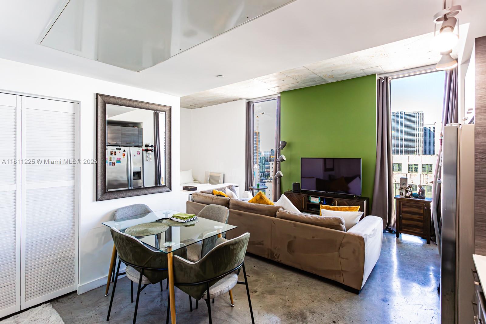 151 Southeast 1st Street, Unit 2204 Miami, FL 33131 - Photo 16 of 34 a living room with furniture and a flat screen tv