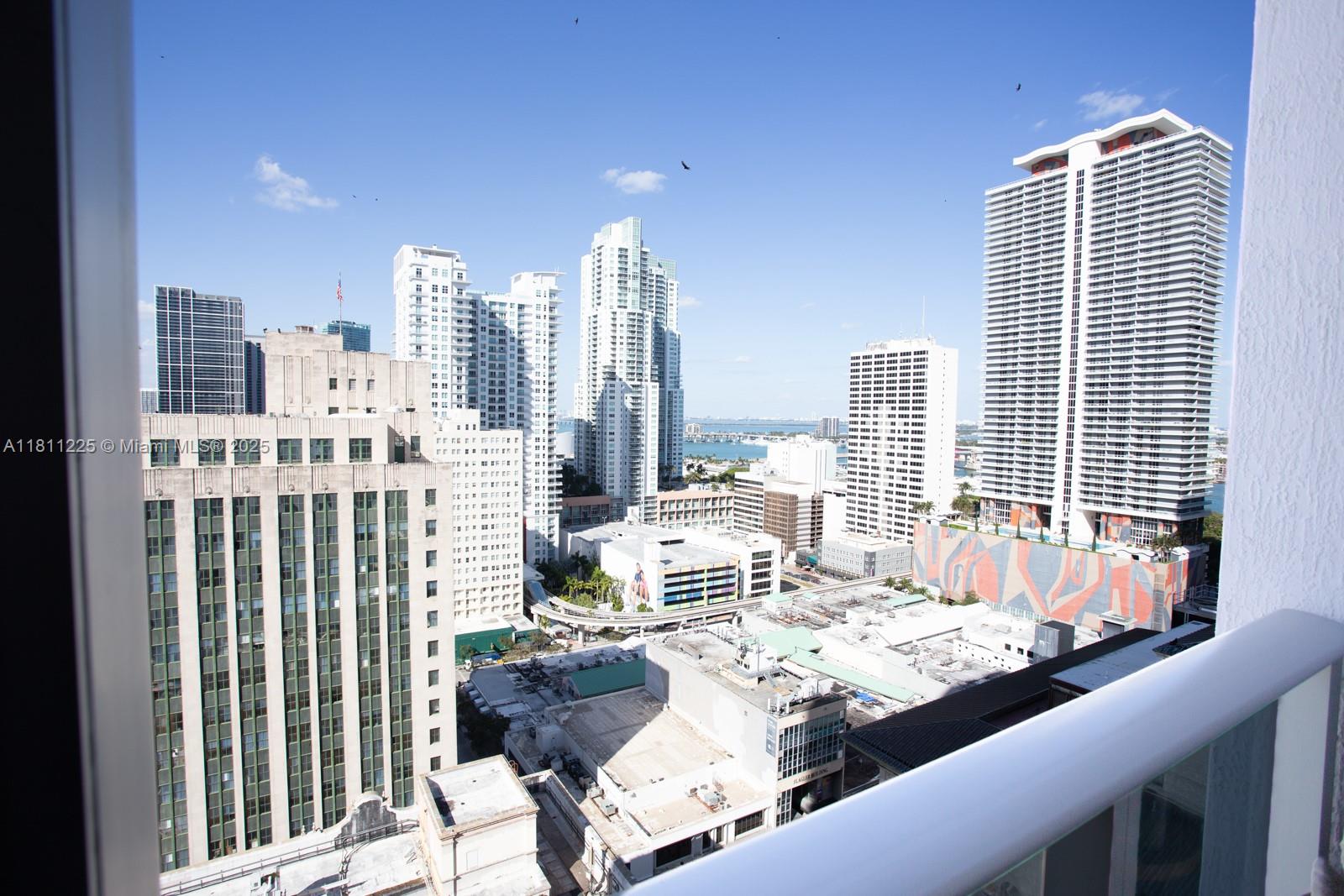 151 Southeast 1st Street, Unit 2204 Miami, FL 33131 - Photo 34 of 34 a living room with furniture and a floor to ceiling window