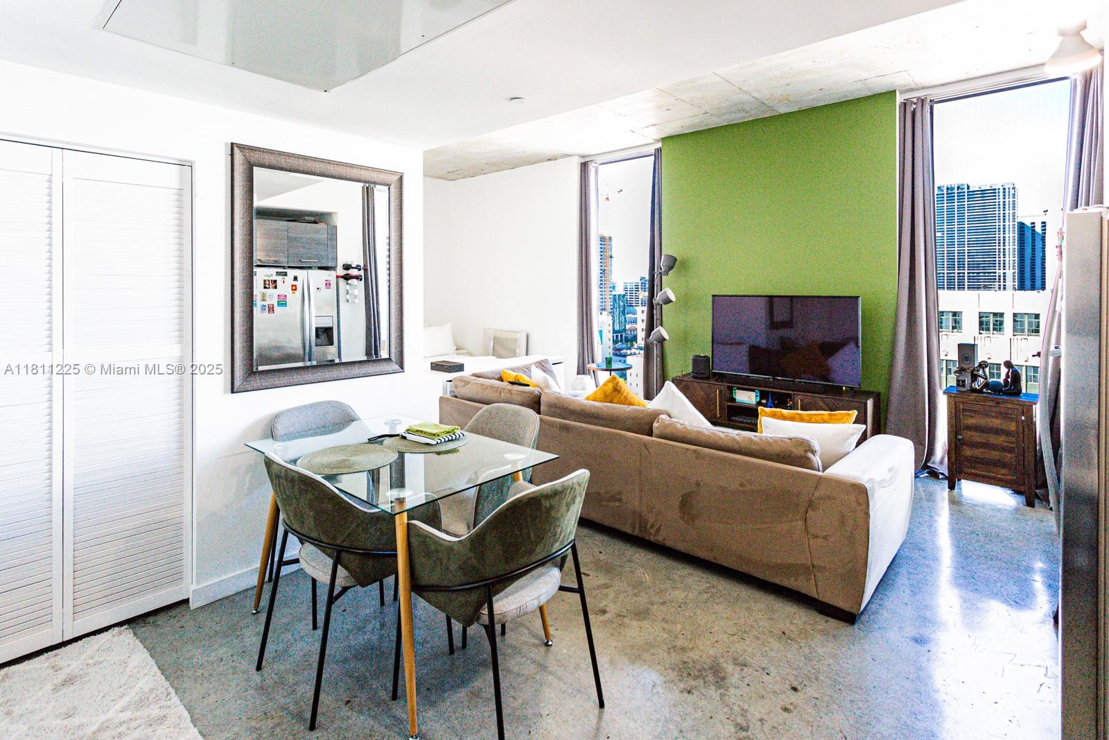 151 Southeast 1st Street, Unit 2204 Miami, FL 33131 - Photo 4 of 34 a living room with furniture and a flat screen tv