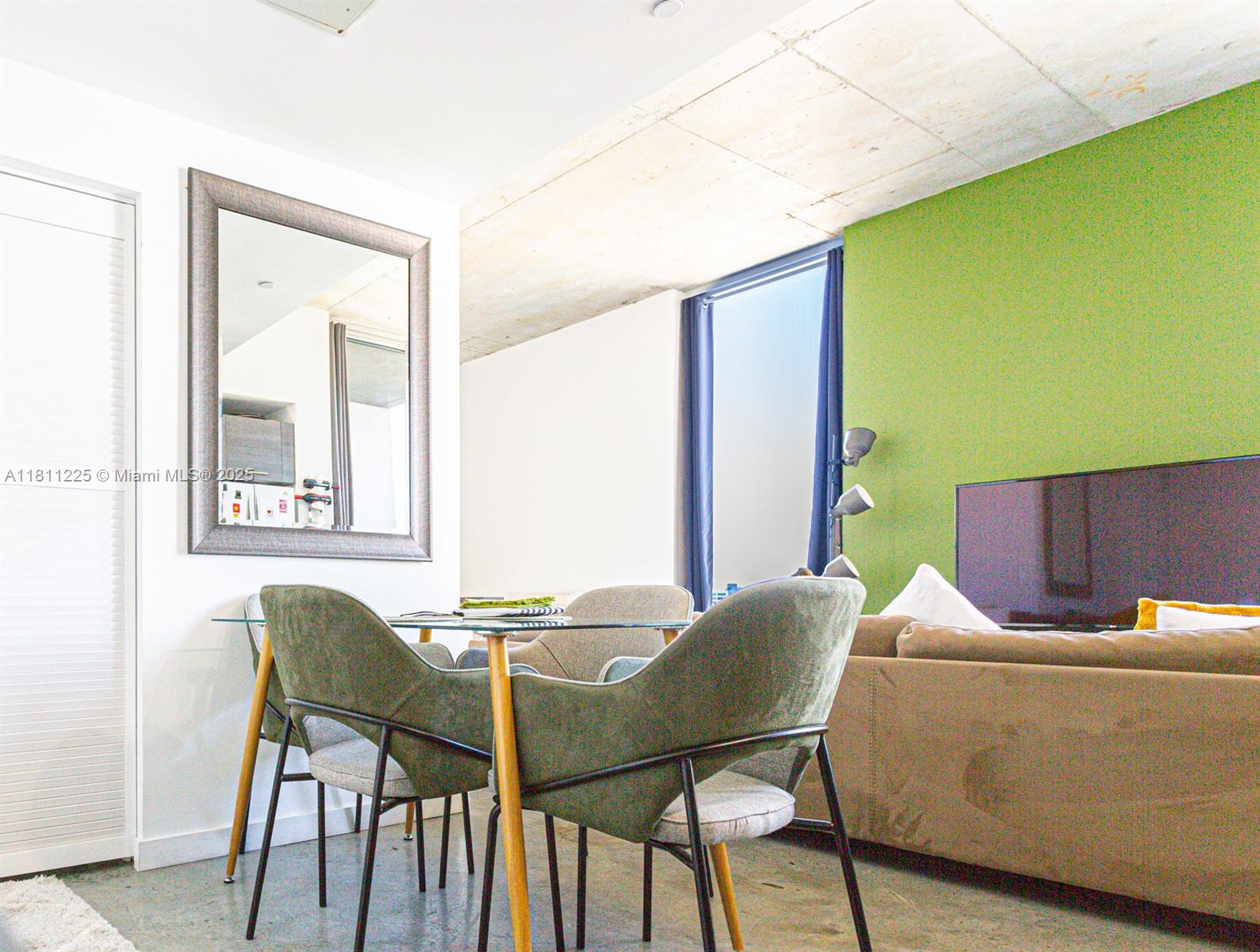 151 Southeast 1st Street, Unit 2204 Miami, FL 33131 - Photo 9 of 34 a living room with a chair and furniture