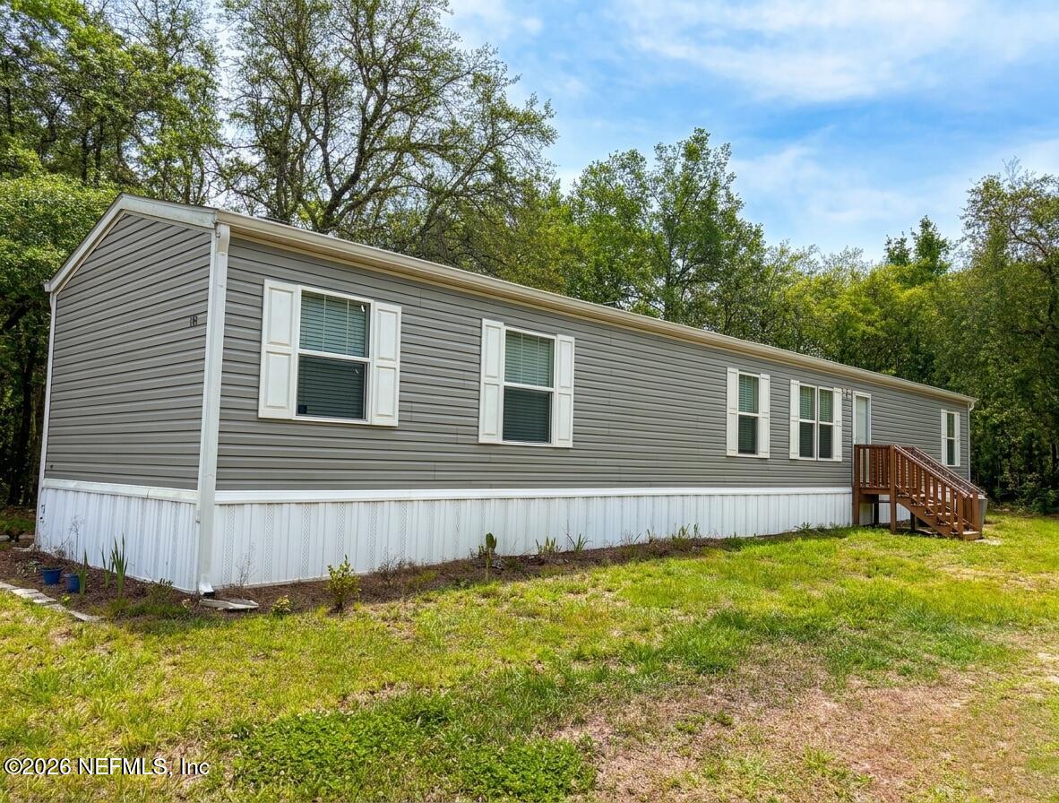 109 Chipo Street Interlachen, FL 32148 - Photo 1 of 1 a house view with a garden space