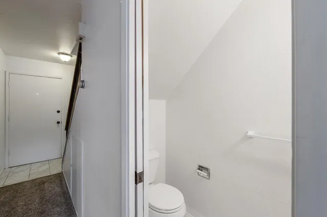 a bathroom with a granite countertop toilet and a shower