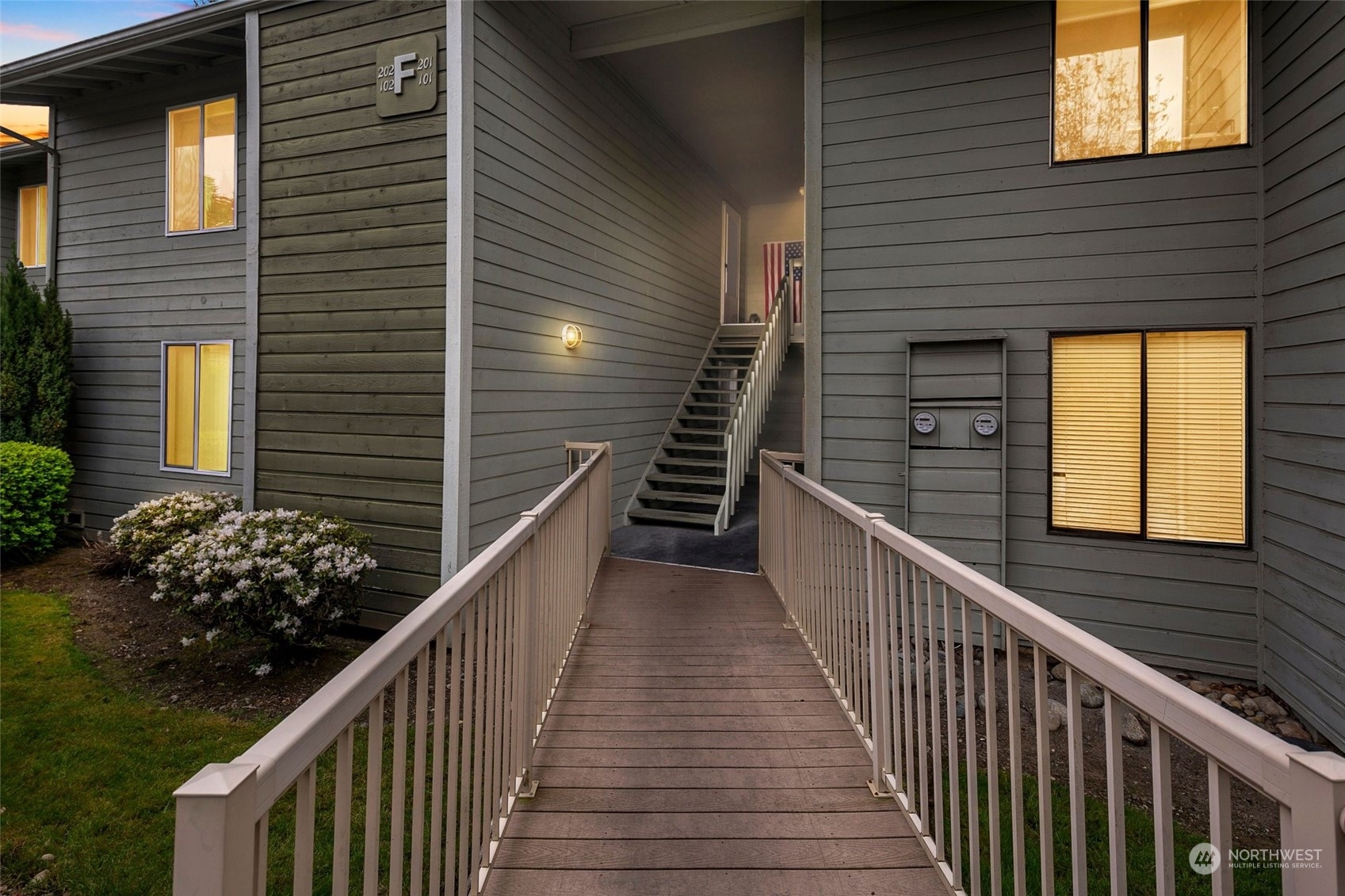 14401 Southeast Petrovitsky Road, Unit F201 Renton, WA 98058 - Photo 3 of 29 a view of a house with wooden stairs and potted plants