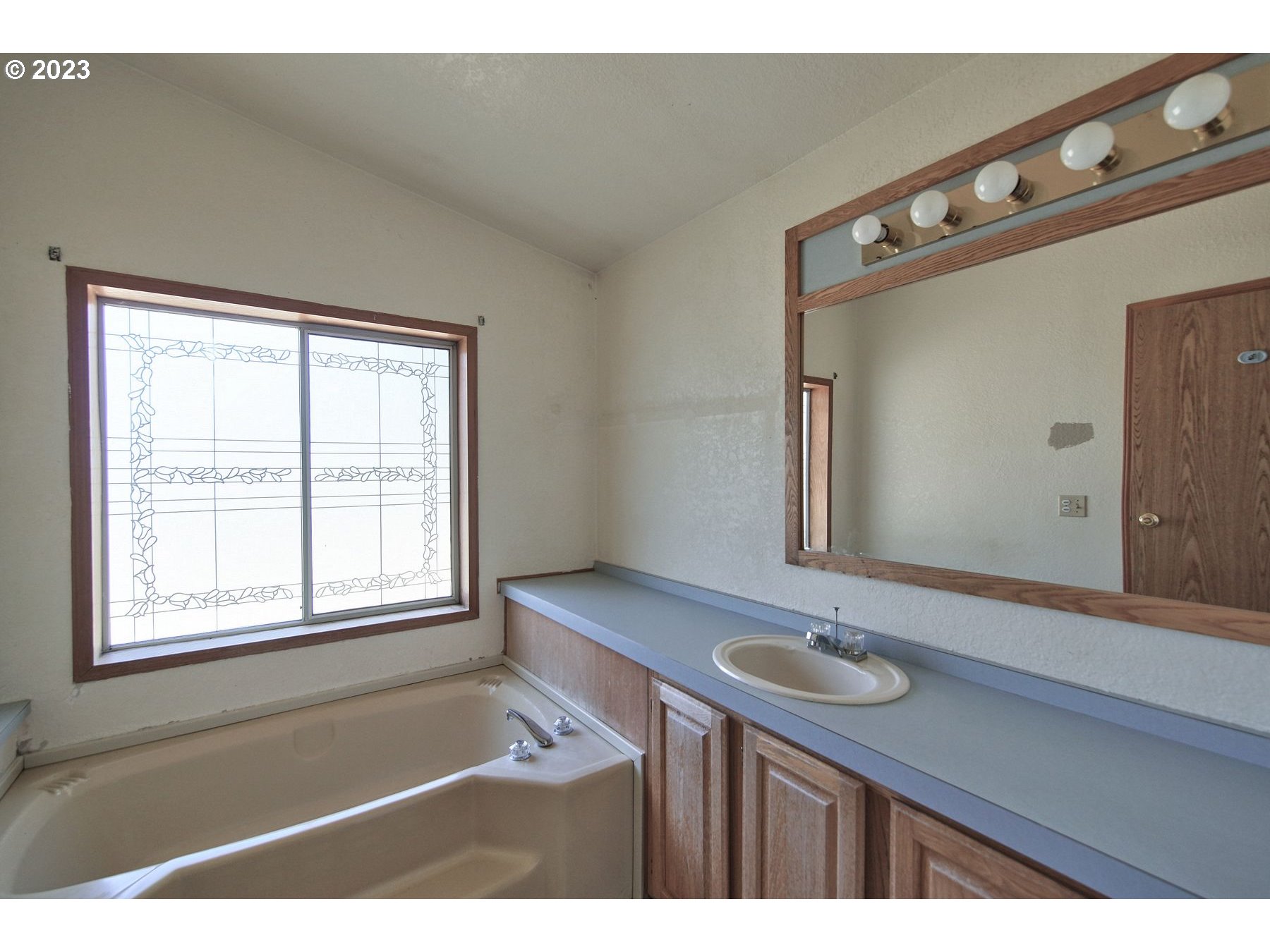 71994 Beaver Springs Road Rainier, OR 97048 - Photo 26 of 37 a bathroom with a sink a mirror and a window