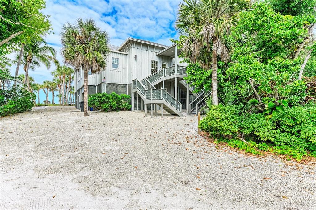 7520 Manasota Key Road Englewood, FL 34223 - Photo 29 of 96 a view of a house with a yard and potted plants