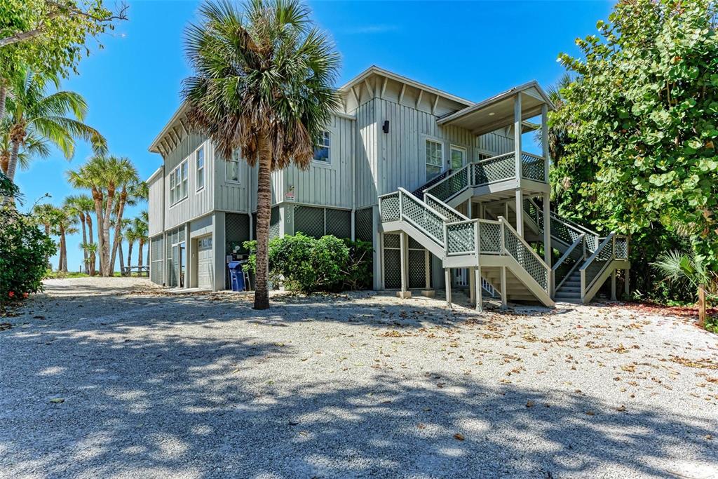 7520 Manasota Key Road Englewood, FL 34223 - Photo 65 of 96 a view of a white house with a snow on the road