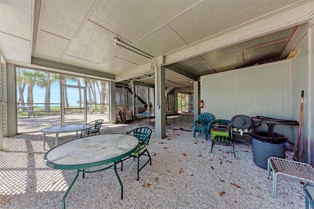 7520 Manasota Key Road Englewood, FL 34223 - Photo 85 of 96 a table and chairs in a patio