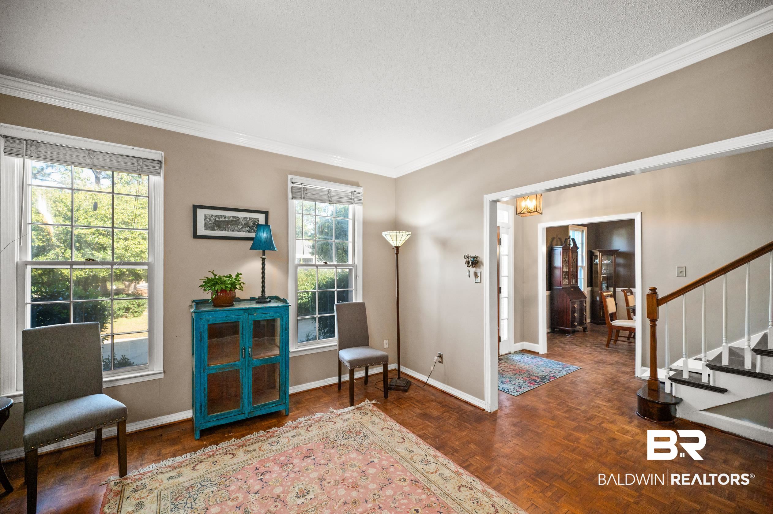 6705 Ridgeland Road South Mobile, AL 36695 - Photo 5 of 44 Sitting room featuring a wealth of natural light, crown molding, and dark parquet floors