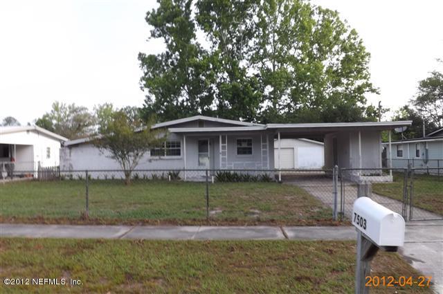 7503 Strato Road Jacksonville, FL 32210 - Photo 1 of 8 a view of a yard in front of a house with large tree