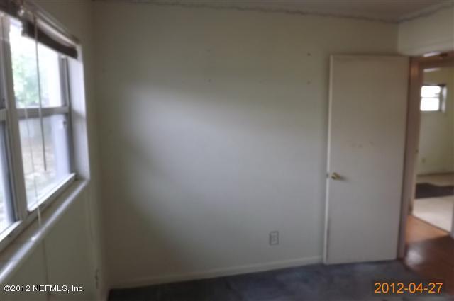 7503 Strato Road Jacksonville, FL 32210 - Photo 5 of 8 a view of an empty room and window