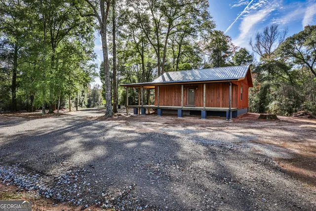 a view of large house with a yard and large trees