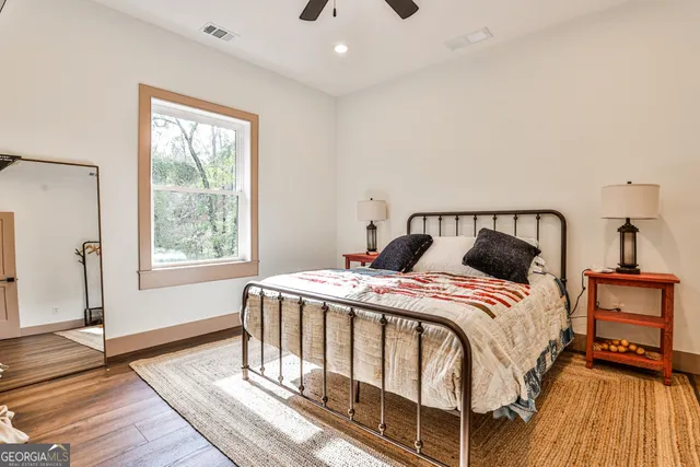 a bedroom with a bed next to a window