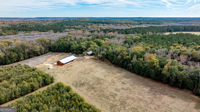 an aerial view of a house with a yard