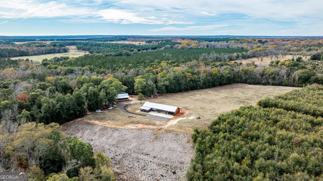 a view of a dry yard with wooden fence