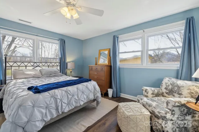 a bedroom with a large bed and a chandelier