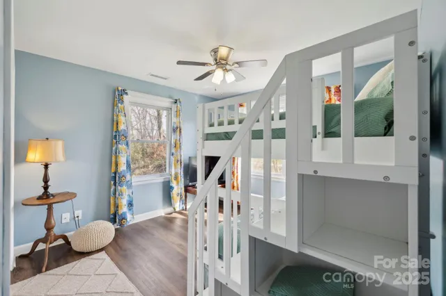 a bedroom with furniture window and a ceiling fan
