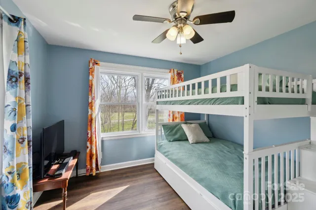 a bathroom with a granite countertop sink mirror and a toilet