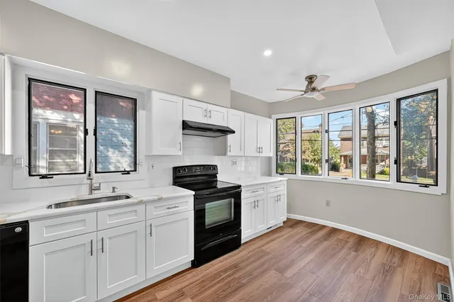 a kitchen with stainless steel appliances a stove sink and cabinets