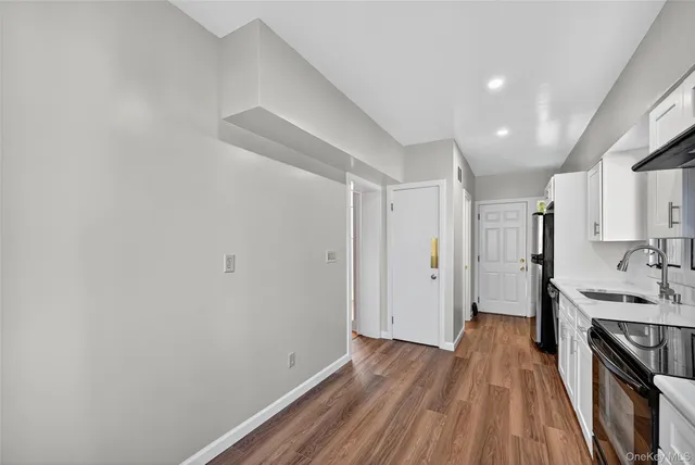 a view of a kitchen from the hallway