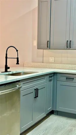 a kitchen with a sink a microwave a refrigerator and cabinets