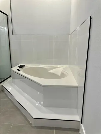 a bathroom with a glass shower door