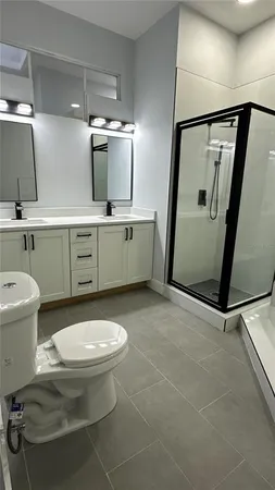a bathroom with a tub sink and a mirror
