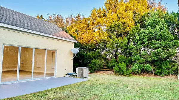 a view of a backyard with large trees
