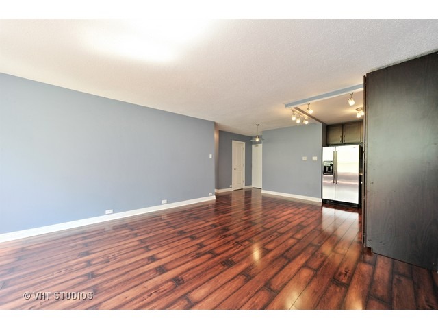 2930 North Sheridan Road, Unit 511 Chicago, IL 60657 - Photo 3 of 10 a view of an empty room and wooden floor