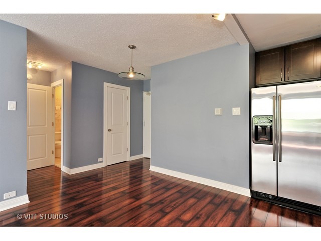 2930 North Sheridan Road, Unit 511 Chicago, IL 60657 - Photo 8 of 10 a view of a kitchen with wooden floor