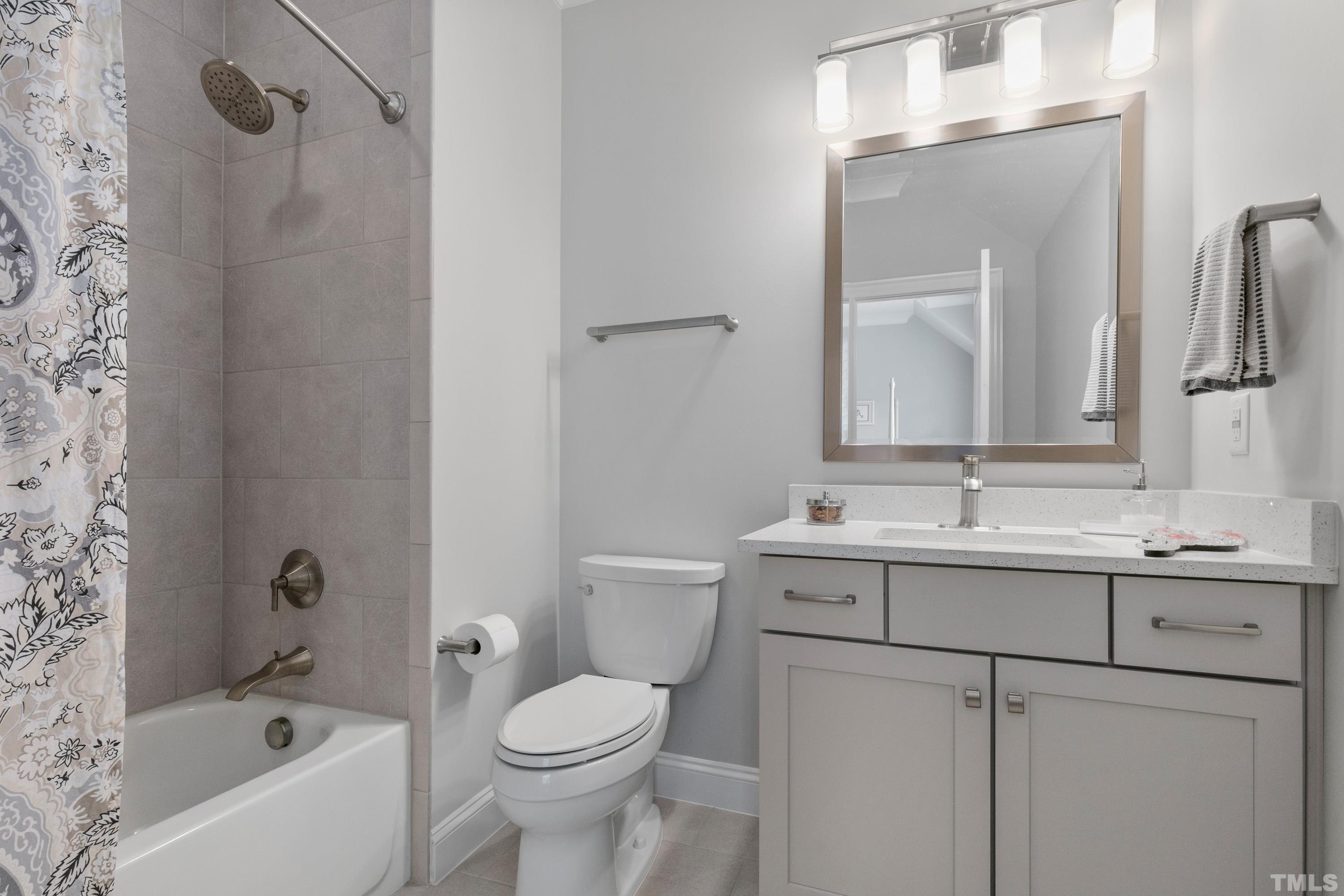 8017 Shree Court Raleigh, NC 27613 - Photo 15 of 30 a bathroom with a sink a toilet and shower
