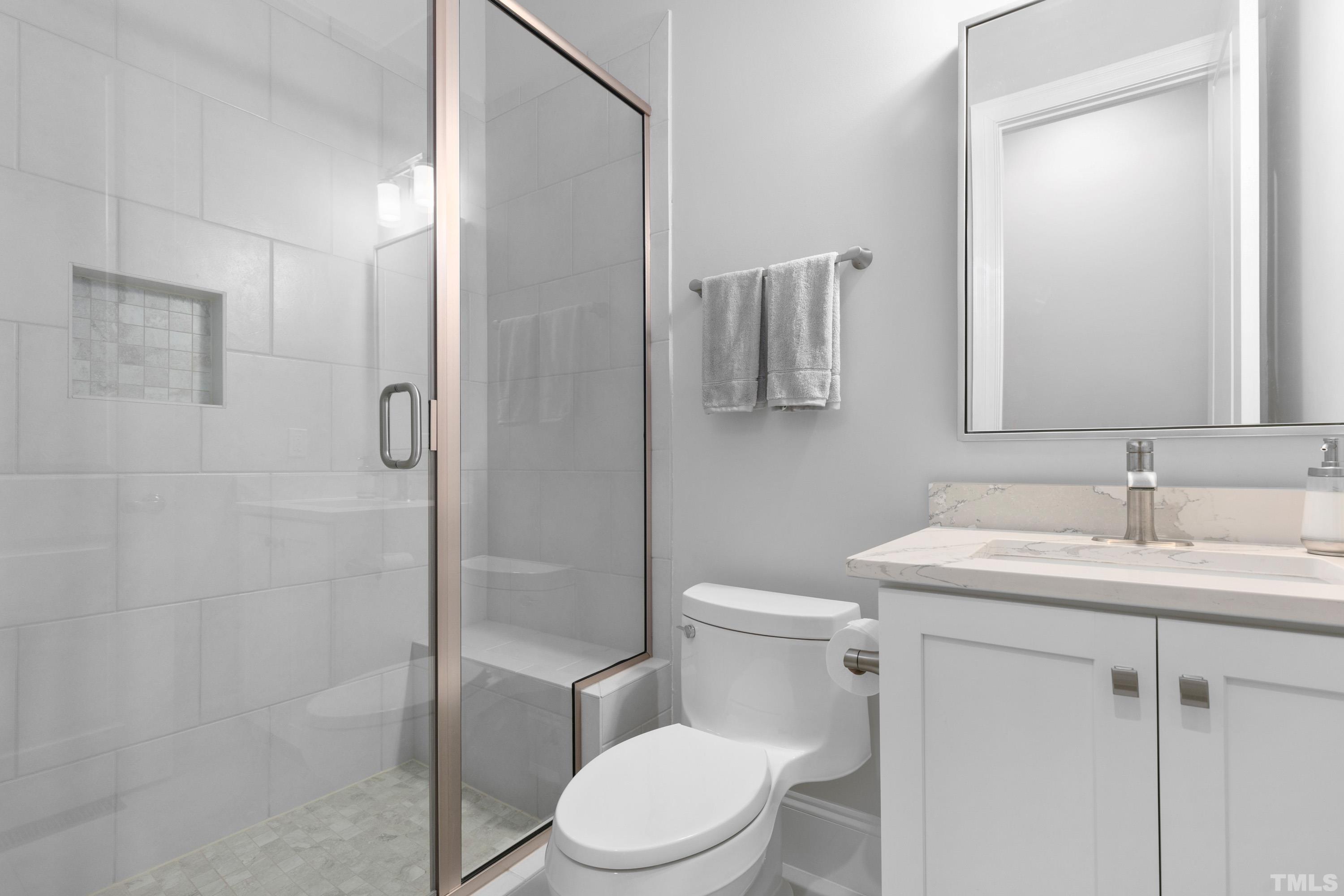 8017 Shree Court Raleigh, NC 27613 - Photo 23 of 30 a bathroom with a toilet sink vanity and shower