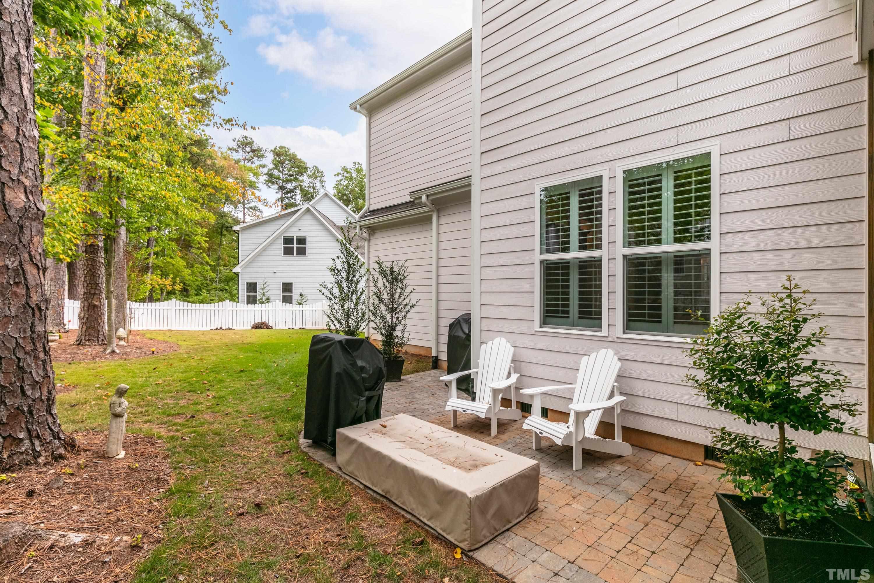 8017 Shree Court Raleigh, NC 27613 - Photo 27 of 30 a row of table and chairs in front of house