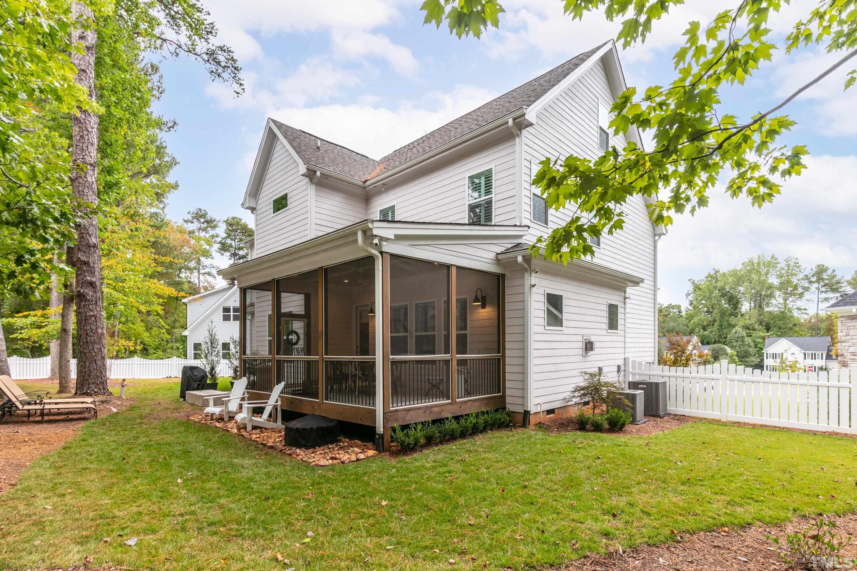 8017 Shree Court Raleigh, NC 27613 - Photo 30 of 30 a view of a house with a large window and a yard with wooden fence