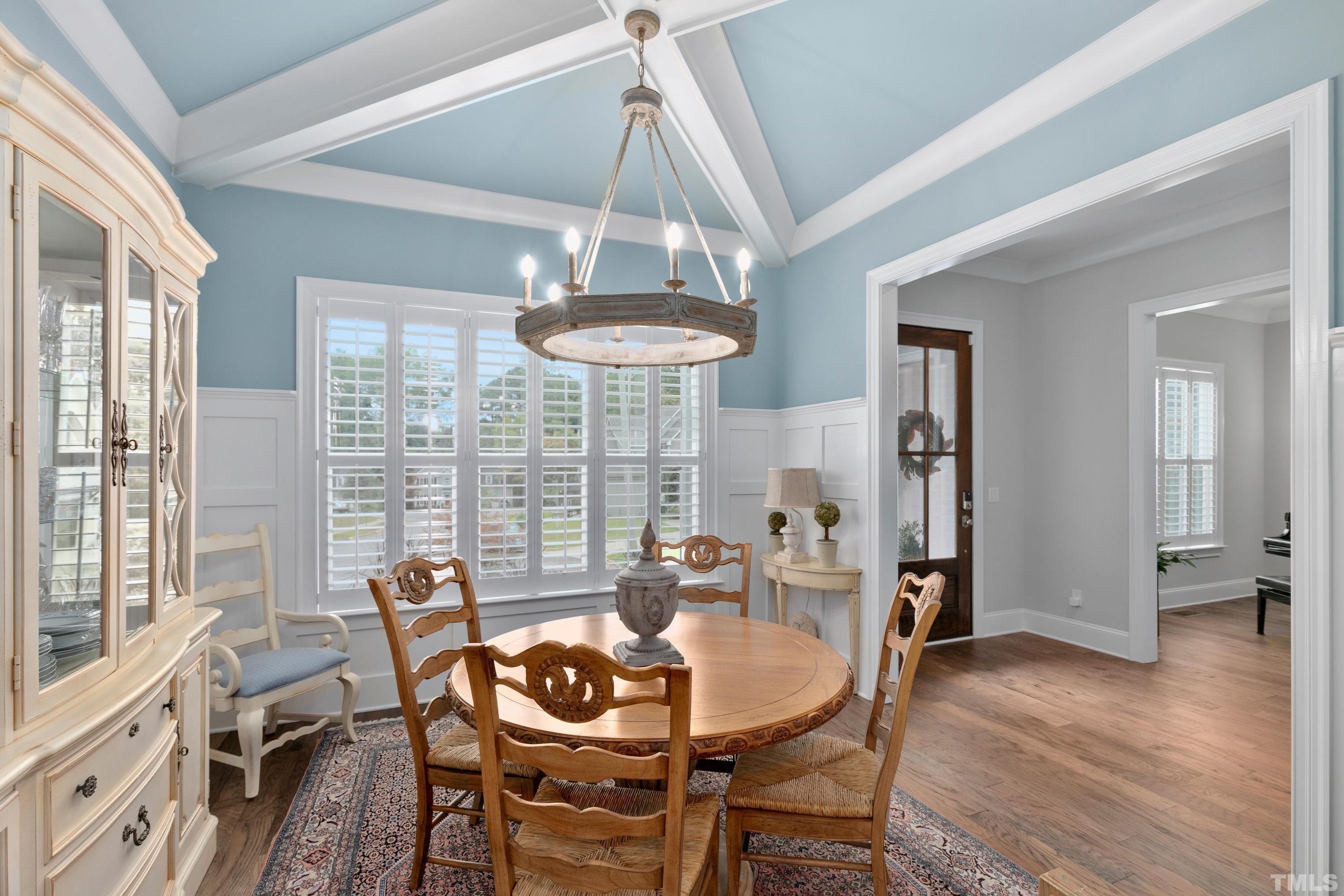 8017 Shree Court Raleigh, NC 27613 - Photo 5 of 30 a dining room with furniture a chandelier and wooden floor