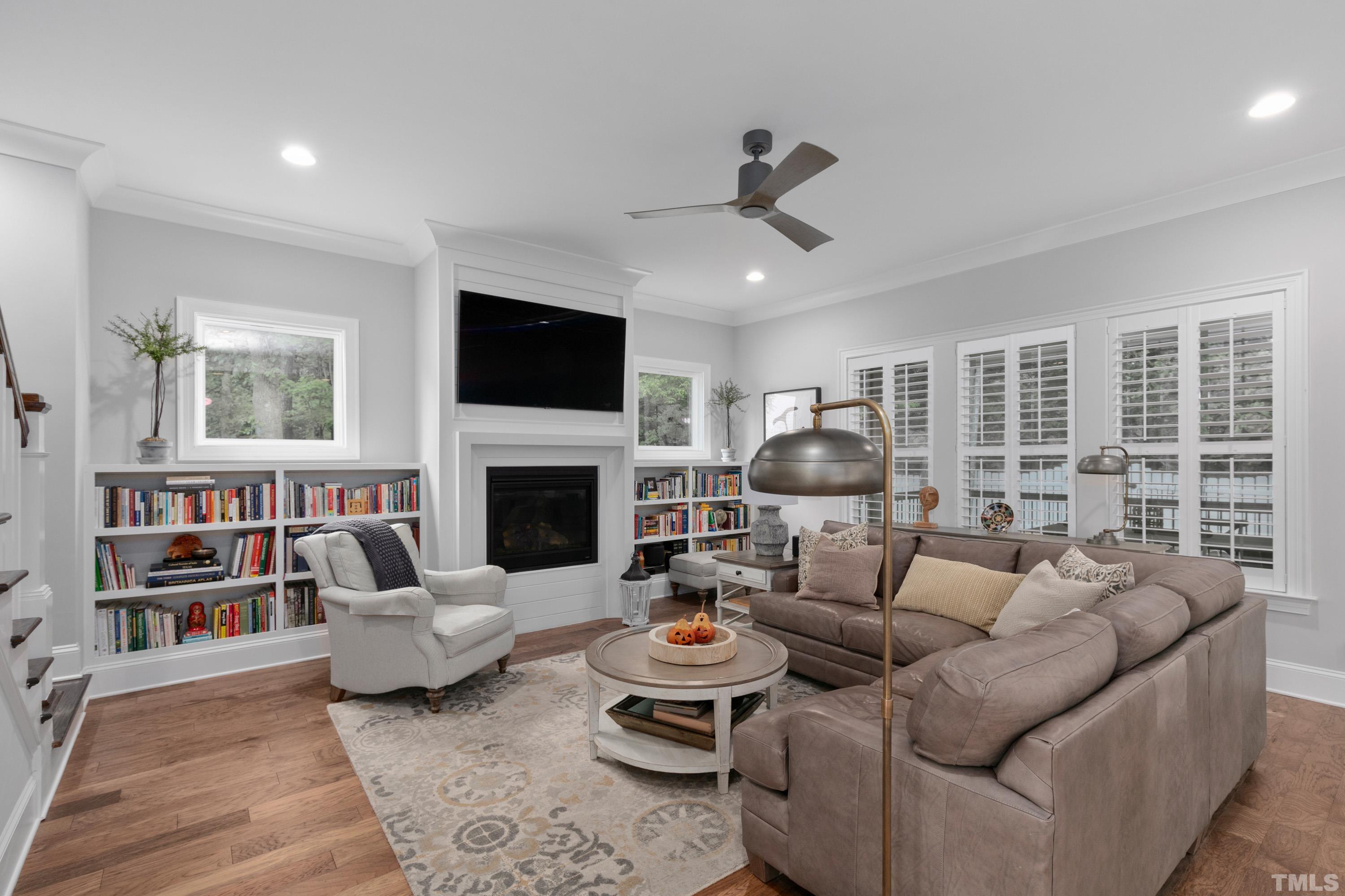 8017 Shree Court Raleigh, NC 27613 - Photo 6 of 30 a living room with furniture fireplace and a flat screen tv