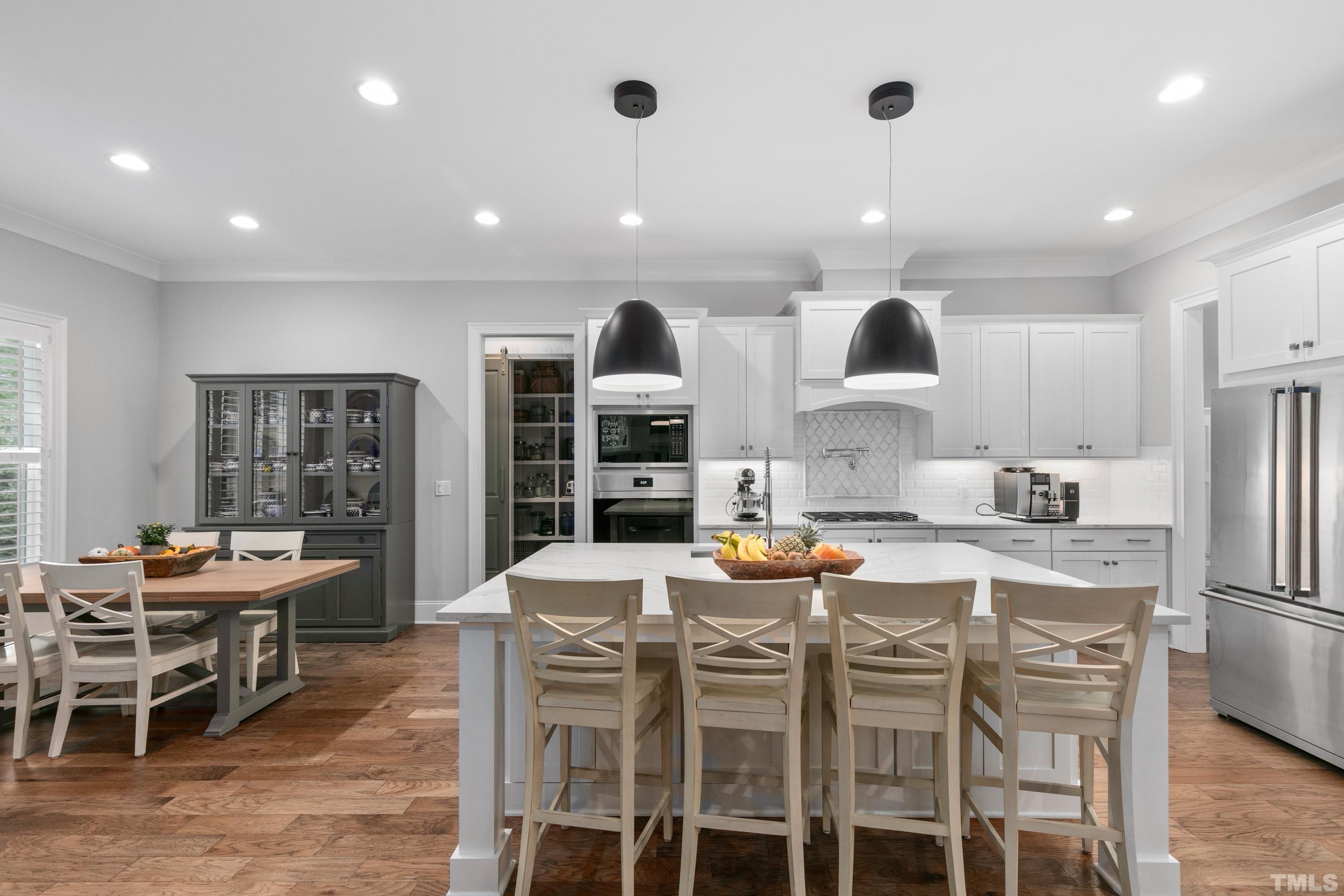 8017 Shree Court Raleigh, NC 27613 - Photo 7 of 30 a large kitchen with a table and chairs