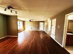 426 Gun Club Road Denison, TX 75021 - Photo 8 of 20 wooden floor in an empty room with a window