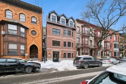 a front view of a residential apartment building with a yard