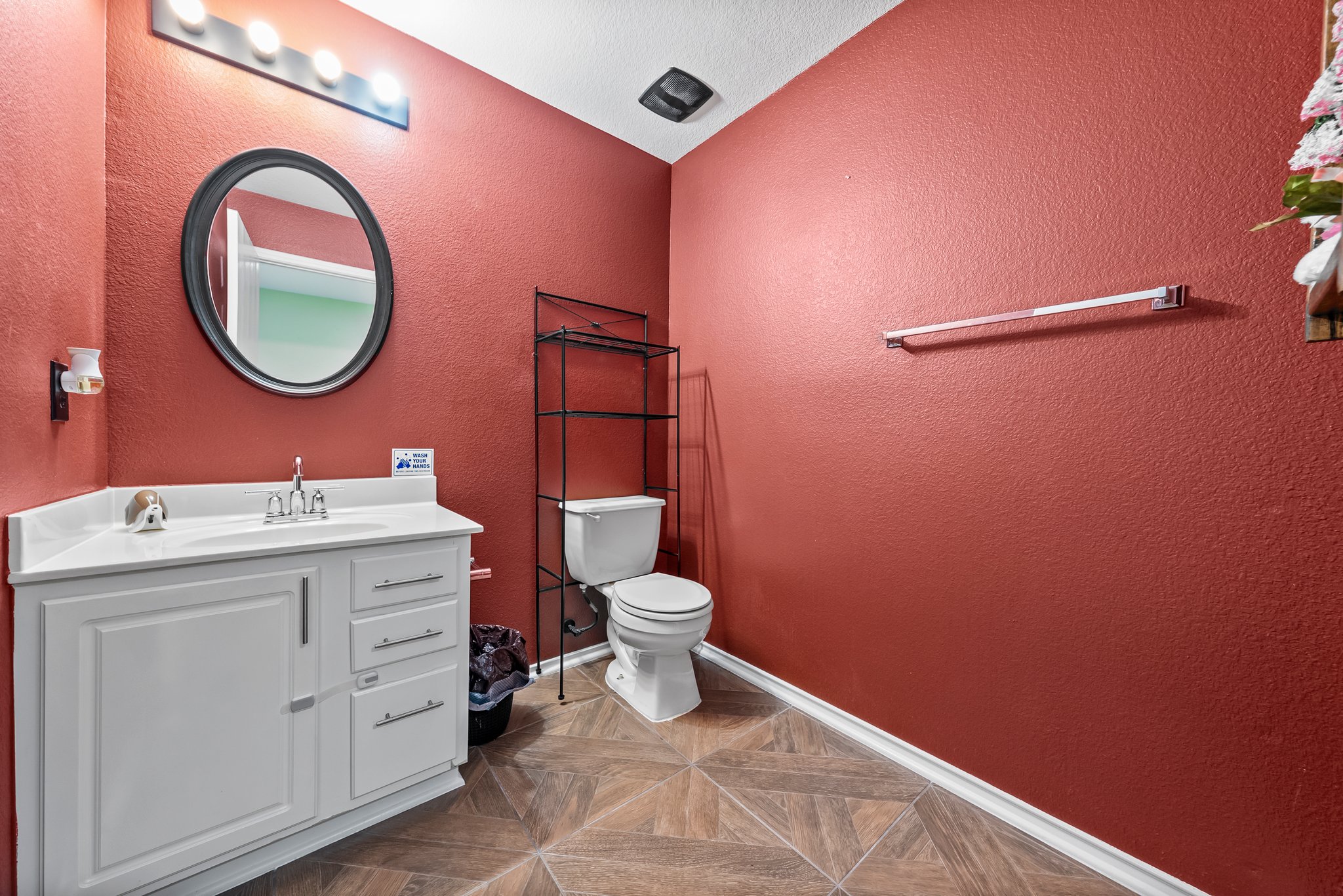 6829 Walkup Lane Austin, TX 78747 - Photo 9 of 18 Modern bath with bright red walls and geometric floor tiling.