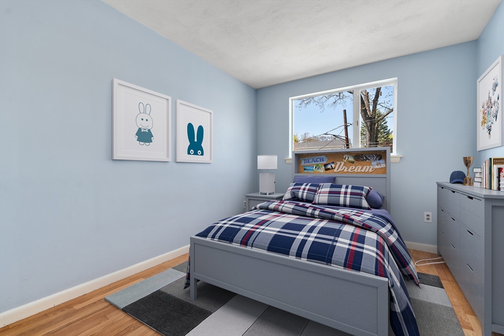 14 Fuller Avenue Newton, MA 02465 - Photo 18 of 27 a bedroom with a bed and wooden floor