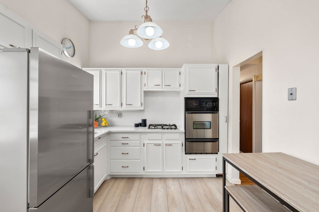 14 Fuller Avenue Newton, MA 02465 - Photo 7 of 27 a kitchen with a refrigerator stove and white cabinets