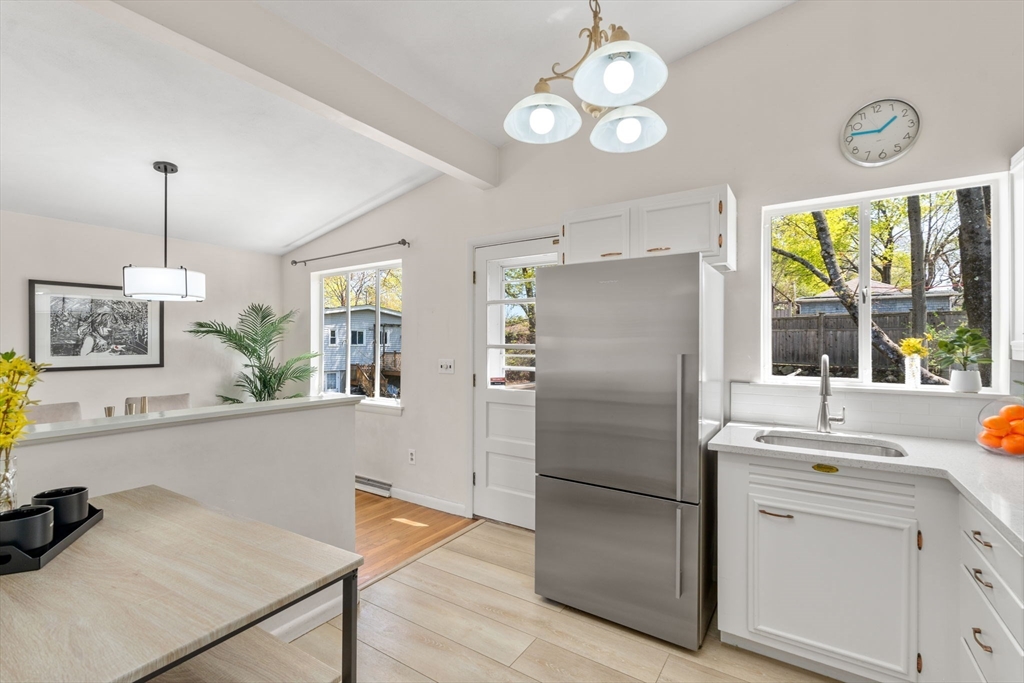 14 Fuller Avenue Newton, MA 02465 - Photo 10 of 27 a kitchen with stainless steel appliances a refrigerator a sink a stove and white cabinets
