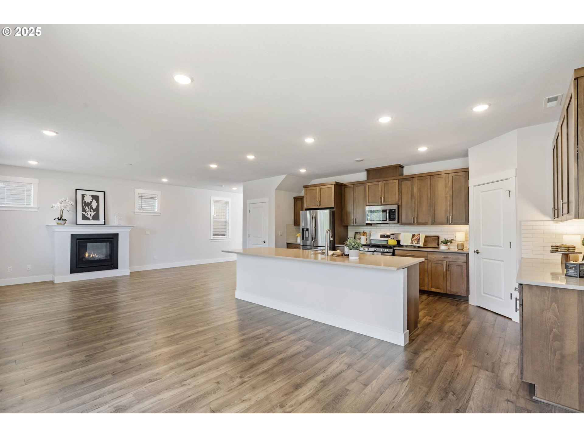 18246 Southwest Silvertip Street Beaverton, OR 97007 - Photo 11 of 46 a kitchen with a refrigerator and a stove top oven