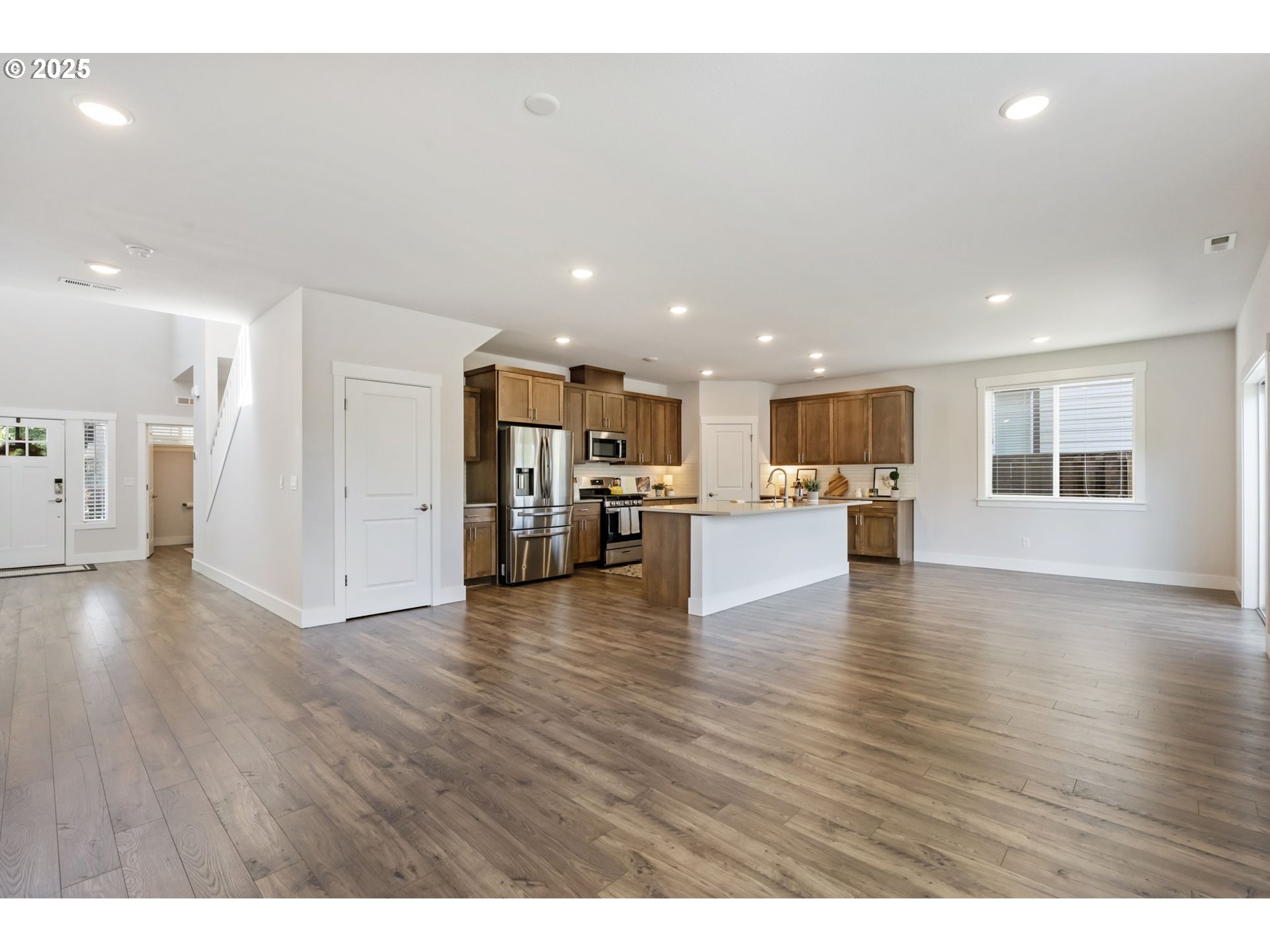 18246 Southwest Silvertip Street Beaverton, OR 97007 - Photo 14 of 46 a view of kitchen with a refrigerator oven a table and chairs
