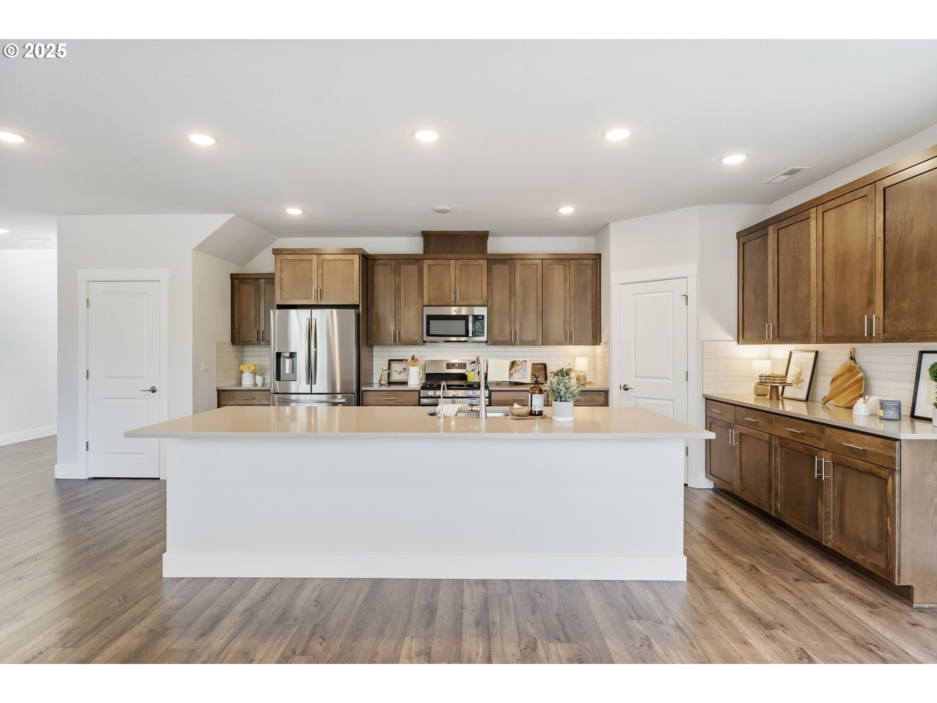18246 Southwest Silvertip Street Beaverton, OR 97007 - Photo 15 of 46 a large kitchen with stainless steel appliances lots of counter space and a sink