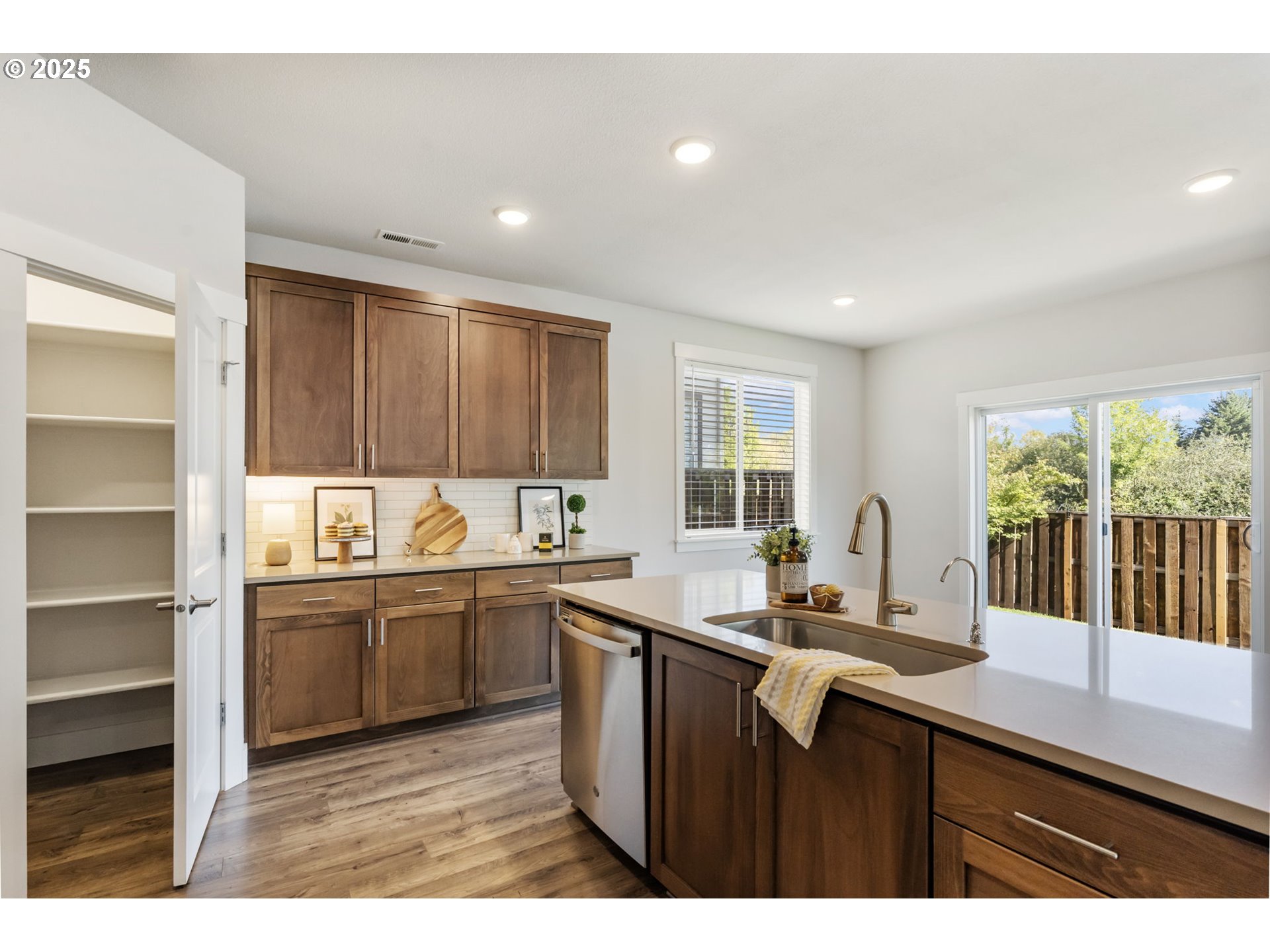 18246 Southwest Silvertip Street Beaverton, OR 97007 - Photo 17 of 46 a kitchen with stainless steel appliances granite countertop a sink stove and cabinets